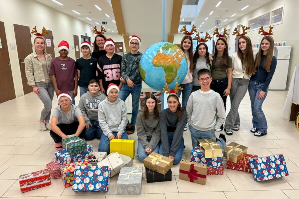 Foto von Schueler und Schuelerinnen der Klasse 3d mit ihren befüllten und verpackten Schuhkartons